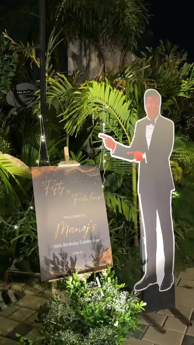 Welcome signage and florals at a 50th birthday celebration